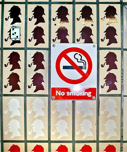 Depictions of Sherlock Holmes smoking his pipe at the Baker Street tube station are obscured by a sign reading "No smoking." Author Dpbsmith posted this to Wikimedia Commons (SA-3.0).